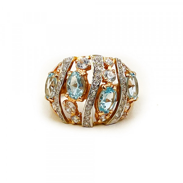 Каблучка з червоного з білим золота з блакитними топазами та цирконом